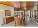 Formal dining area featuring a wood table, wood ceiling, wood floors, and a view of a light-filled home at 2637 Sunburst Ct, Lake Wales, FL 33898
