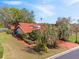 Beautiful single-story home boasting a red tile roof, manicured landscaping, and a vibrant red driveway at 2637 Sunburst Ct, Lake Wales, FL 33898