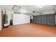 Spacious garage featuring ample storage, epoxy flooring, and an automatic garage door for convenient access at 2637 Sunburst Ct, Lake Wales, FL 33898