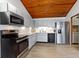 A kitchen with stainless steel appliances, wood-look tile flooring, and bright countertops offers modern functionality at 2637 Sunburst Ct, Lake Wales, FL 33898