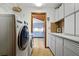 Functional laundry room with modern washer, dryer, counter space and a view to the eat-in kitchen at 2637 Sunburst Ct, Lake Wales, FL 33898