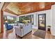 Inviting living room featuring a wood ceiling, tiled floors, and sunroom access at 2637 Sunburst Ct, Lake Wales, FL 33898