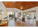 Spacious living room with a vaulted wood ceiling, tiled flooring, and plenty of natural light at 2637 Sunburst Ct, Lake Wales, FL 33898