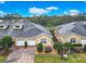 An aerial view of townhomes featuring brick driveways, attached garages, and manicured landscaping at 2723 Rutledge Ct, Winter Haven, FL 33884