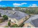 Aerial view showcasing townhomes with brick driveways, two car garages, and meticulous landscaping at 2723 Rutledge Ct, Winter Haven, FL 33884