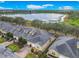 Aerial view of townhomes showcasing well-maintained landscaping and a serene lake backdrop at 2723 Rutledge Ct, Winter Haven, FL 33884