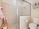 Bright bathroom with a tiled shower, glass door, and convenient toilet at 2723 Rutledge Ct, Winter Haven, FL 33884