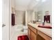 Bathroom with a large mirror, white cabinets, and combined shower-tub behind a curtain at 2723 Rutledge Ct, Winter Haven, FL 33884