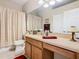 Bright bathroom featuring a large mirror, updated vanity, and shower-tub combination at 2723 Rutledge Ct, Winter Haven, FL 33884