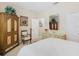 Serene bedroom with neutral tones, ornate armoire, and a comfy bed at 2723 Rutledge Ct, Winter Haven, FL 33884