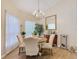 Bright dining room with a modern chandelier, large window, and elegant decor at 2723 Rutledge Ct, Winter Haven, FL 33884