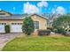 Inviting home exterior with a two car garage, complemented by fresh green landscaping at 2723 Rutledge Ct, Winter Haven, FL 33884