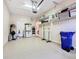 Spacious garage featuring epoxy floors and ample storage with shelving and cabinets at 2723 Rutledge Ct, Winter Haven, FL 33884