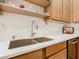 A kitchen sink with stainless steel appliances, white counter tops, and ample cabinet space at 2723 Rutledge Ct, Winter Haven, FL 33884