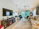 Bright living room with a flat screen TV, fireplace, fan, and sliding glass doors to the lanai at 2723 Rutledge Ct, Winter Haven, FL 33884
