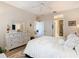 Relaxing main bedroom with light walls, ceiling fan, ensuite bath, and white dresser at 2723 Rutledge Ct, Winter Haven, FL 33884