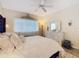 Cozy main bedroom featuring a white dresser, soft lighting, and a decorative headboard at 2723 Rutledge Ct, Winter Haven, FL 33884