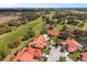 Birds eye view of homes and townhouses alongside a golf course on a sunny day at 2725 Clubhouse Dr, Lake Wales, FL 33898