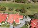 Bird's-eye view of a red tiled roof home on a golf course surrounded by lush trees and picturesque scenery at 2725 Clubhouse Dr, Lake Wales, FL 33898