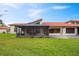 Wide lawn with barrel tile roof with screened-in porch, exterior view at 2725 Clubhouse Dr, Lake Wales, FL 33898