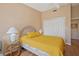 Bright bedroom featuring a woven headboard, side table lamps, and closet at 2725 Clubhouse Dr, Lake Wales, FL 33898