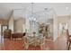 Dining area with a glass top table, chandelier, and mirrored wall at 2725 Clubhouse Dr, Lake Wales, FL 33898