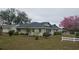 Expansive backyard with mature trees and white picket fence, perfect for outdoor activities at 3065 E Central Ave, Bartow, FL 33830