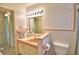 A full bathroom with a single sink vanity, a tile backsplash, and a toilet next to the shower at 3065 E Central Ave, Bartow, FL 33830
