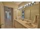 Well-lit bathroom showcasing a large mirror with lots of counter space and access to additional rooms at 3065 E Central Ave, Bartow, FL 33830