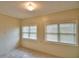 Cozy bedroom featuring neutral walls, tiled floors, and light-filtering window blinds at 3065 E Central Ave, Bartow, FL 33830