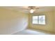 Bright bedroom featuring a ceiling fan, a window with blinds, and neutral paint and carpet at 3065 E Central Ave, Bartow, FL 33830