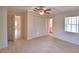 Bright bedroom featuring a ceiling fan, closet space, and an adjacent bathroom for added comfort and convenience at 3065 E Central Ave, Bartow, FL 33830