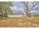 Wide backyard of the property featuring mature trees at 3065 E Central Ave, Bartow, FL 33830