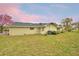Spacious backyard featuring a well-maintained lawn and exterior of the home at 3065 E Central Ave, Bartow, FL 33830