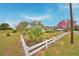 Exterior view of the house with a well-manicured lawn and white picket fence at 3065 E Central Ave, Bartow, FL 33830