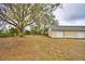 Exterior view of a building with multiple garages and a large grassy yard at 3065 E Central Ave, Bartow, FL 33830