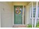 Close-up of the front door with decorative wreath and sidelight window at 3065 E Central Ave, Bartow, FL 33830