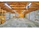 Spacious garage featuring exposed wood rafters, cinder block walls, and two garage doors at 3065 E Central Ave, Bartow, FL 33830