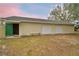 Exterior view of detached garage with white doors and adjacent lawn area at 3065 E Central Ave, Bartow, FL 33830