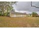 Detached garage with a light-colored exterior and green garage door at 3065 E Central Ave, Bartow, FL 33830