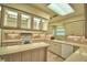 Bright kitchen features white cabinets, tile backsplash, and counter seating with a skylight at 3065 E Central Ave, Bartow, FL 33830