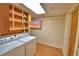 Utility room with a washer, dryer, built in shelving, and tile flooring at 3065 E Central Ave, Bartow, FL 33830