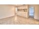 Spacious living room featuring custom built-in cabinets and neutral tile flooring, great for storage and organization at 3065 E Central Ave, Bartow, FL 33830