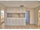 Bright living room showcasing custom built-in cabinets with tile flooring, offering lots of storage and style at 3065 E Central Ave, Bartow, FL 33830