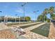 Community shuffleboard courts surrounded by beautiful landscaping, benches and sidewalks at 3416 Grenville Dr, Winter Haven, FL 33884