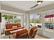 Bright sunroom with views of the backyard and pond, featuring comfortable seating and decor at 3416 Grenville Dr, Winter Haven, FL 33884