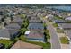 Aerial view of a comfortable home with beautiful landscaping and a lake view in a well-established neighborhood at 3686 Plymouth Dr, Winter Haven, FL 33884