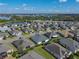 Aerial view of a home in a lakeside community, featuring lush lawns and tree-lined streets at 3686 Plymouth Dr, Winter Haven, FL 33884