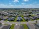 An aerial view of a home in a meticulously maintained community with lush landscaping and a serene water view at 3686 Plymouth Dr, Winter Haven, FL 33884