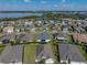 An aerial view of a well-kept home in a friendly neighborhood near a sparkling lake, offering a peaceful setting at 3686 Plymouth Dr, Winter Haven, FL 33884